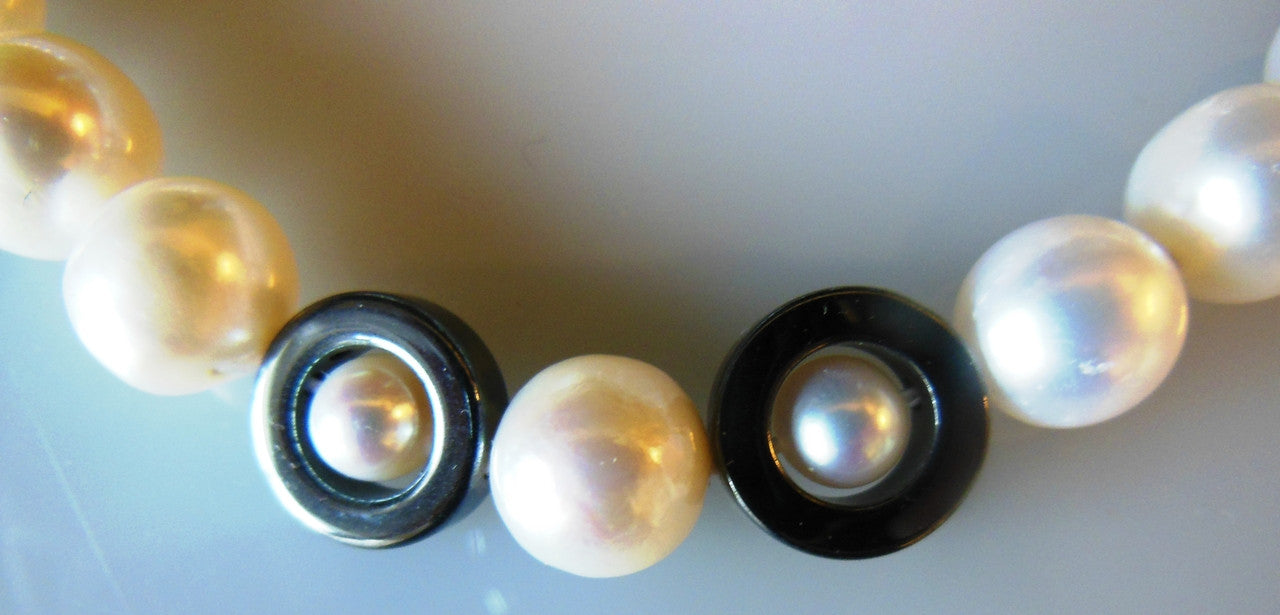 Hematite Circles and asymetric beads on white pearls