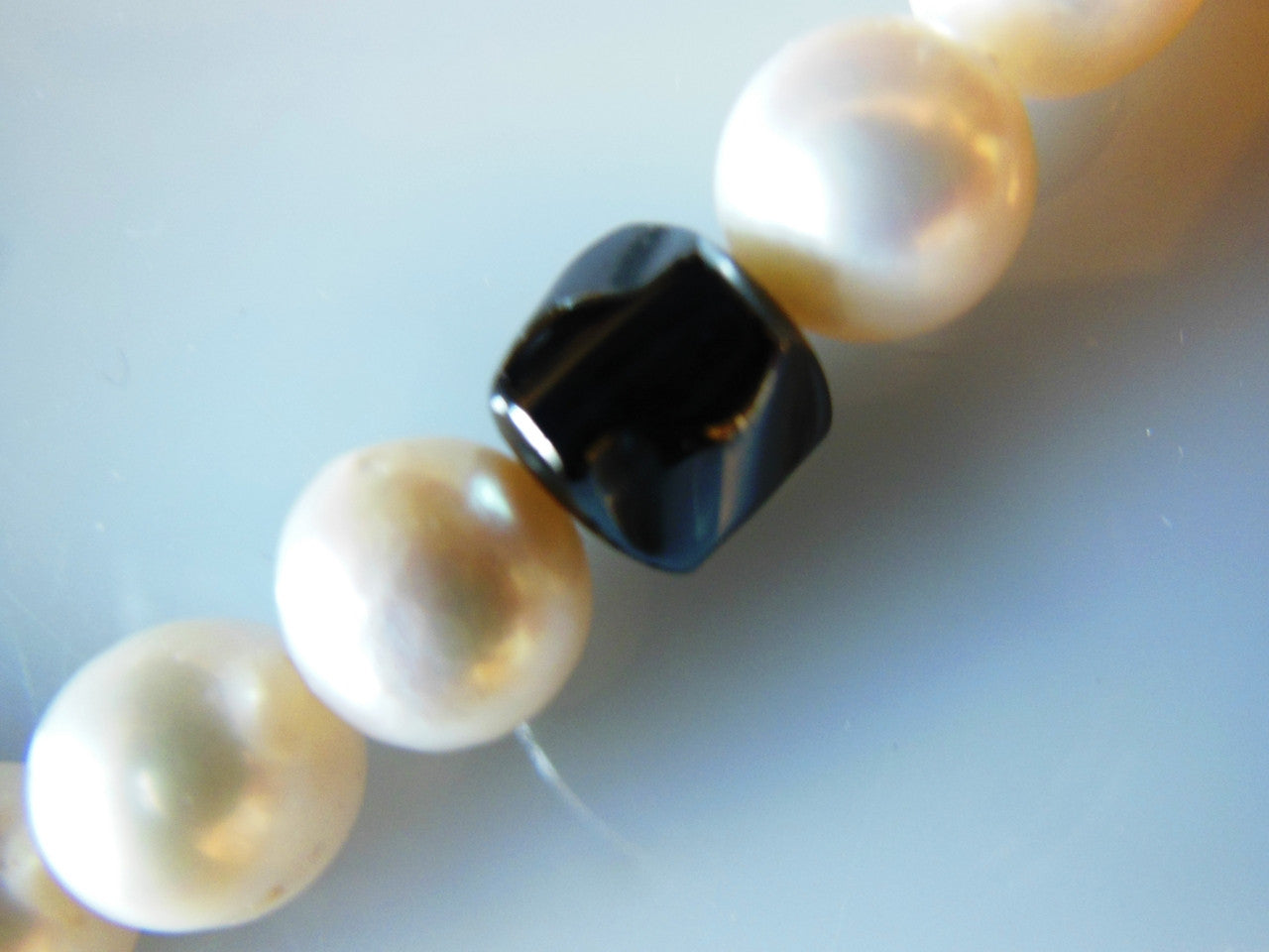 Hematite Circles and asymetric beads on white pearls