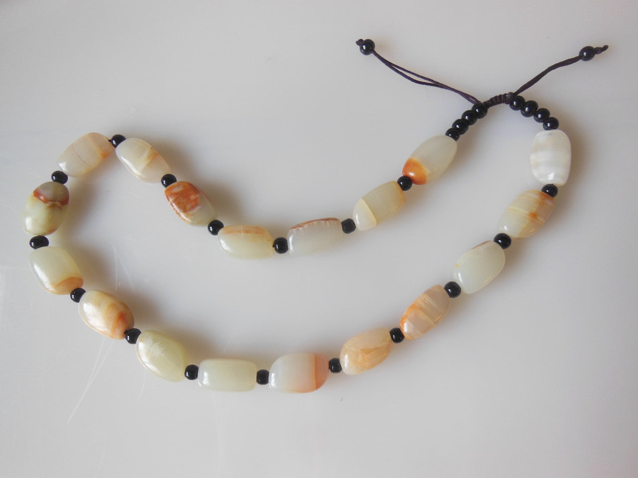 Jade beaded necklace from China.  Black and cream with shades of bronze.-4