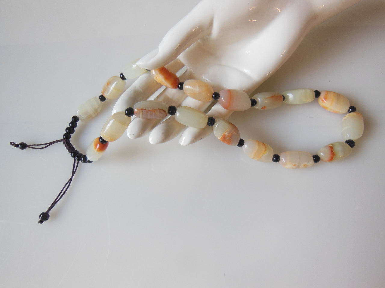 Jade beaded necklace from China.  Black and cream with shades of bronze.-2