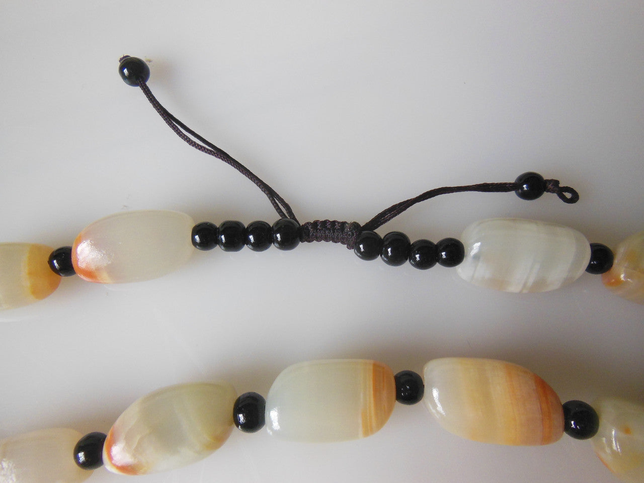 Jade beaded necklace from China.  Black and cream with shades of bronze.-3
