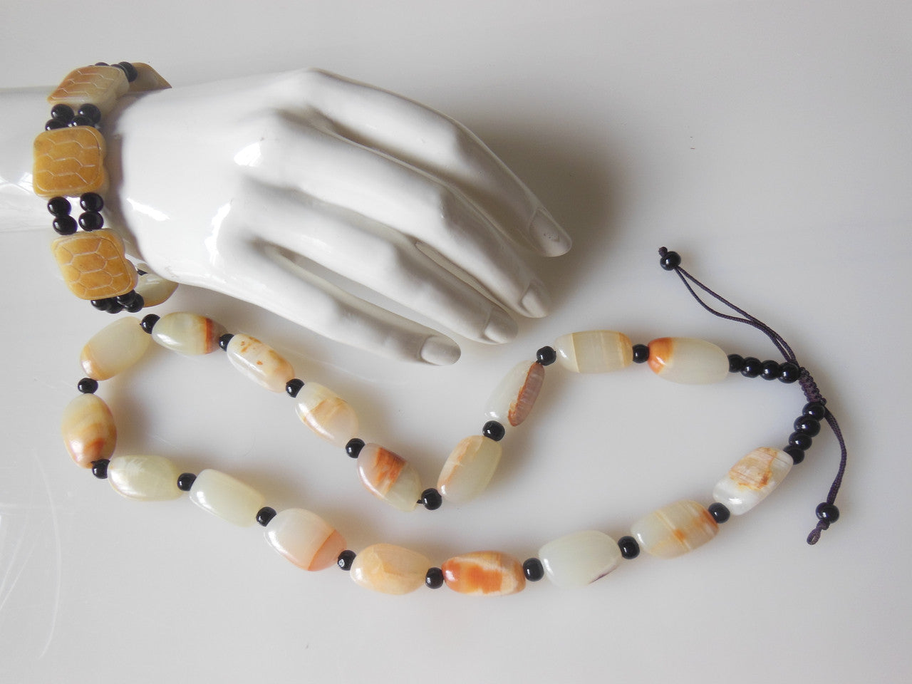 Jade beaded necklace from China.  Black and cream with shades of bronze.-5