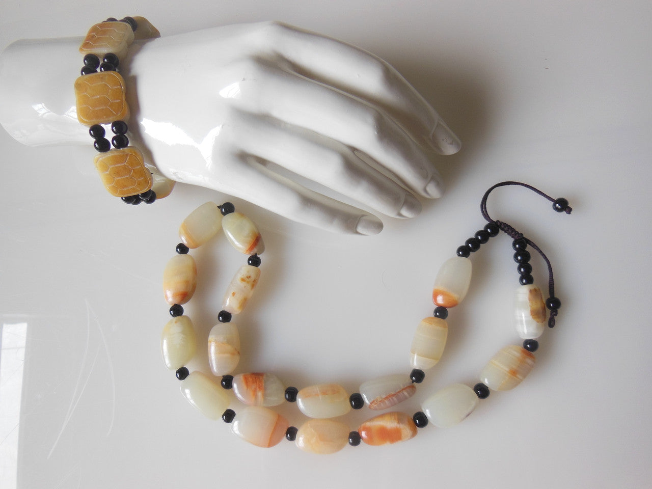 Jade beaded necklace from China.  Black and cream with shades of bronze.-6