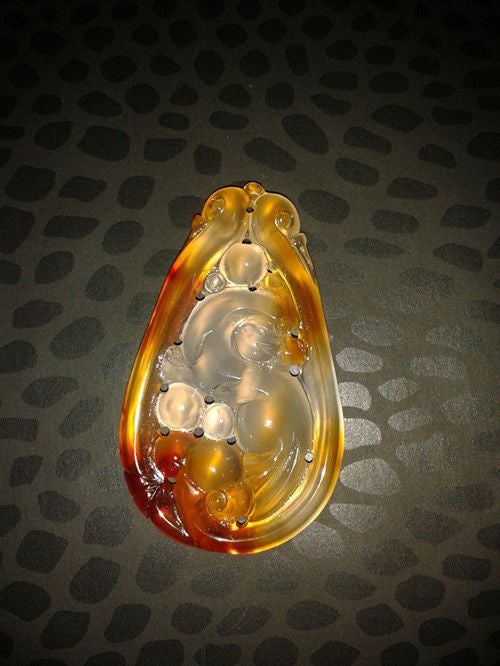 Jade pendant. Carved in swirls called Essence.  Lovely shades of bronze.-0