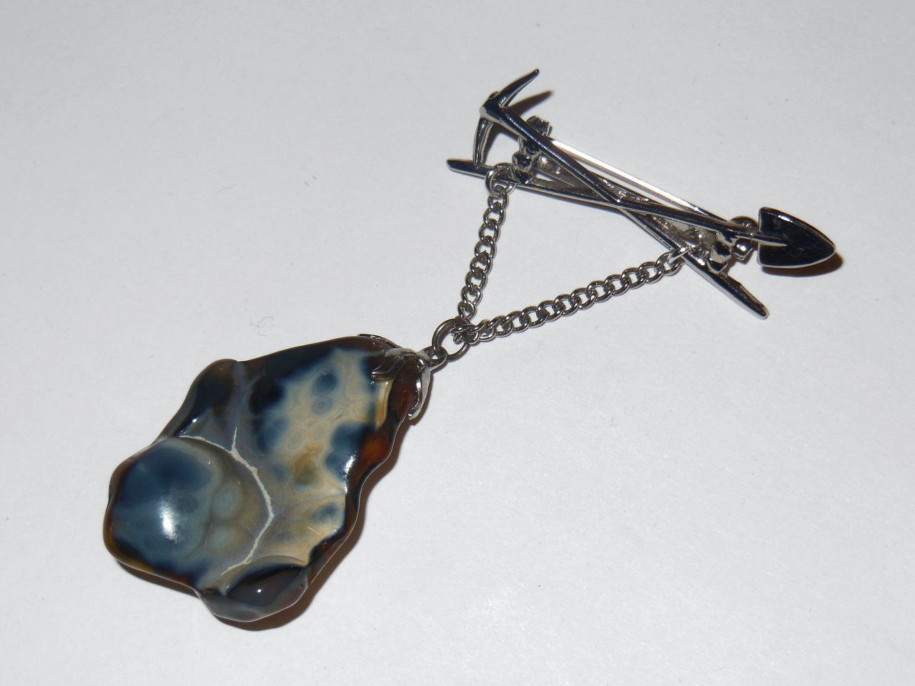 Vintage Brooch- Cris-cross Tools with Mystery Blue Stone-1